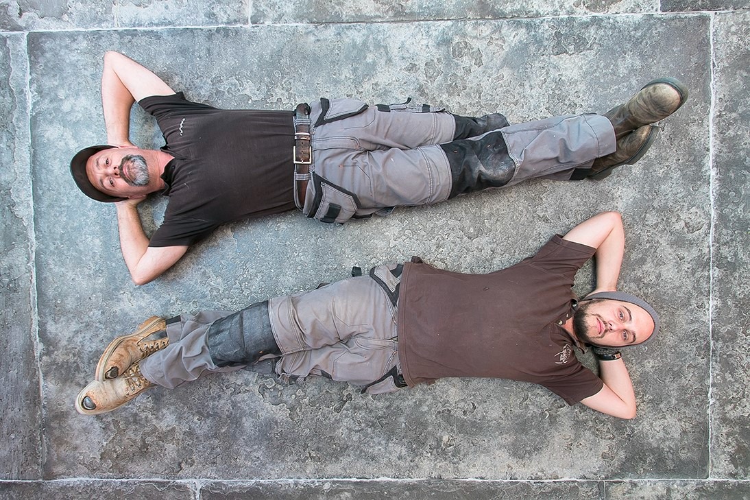James Thurtle and team member restoring traditional flagstone floor